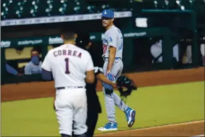  ?? DAVID J. PHILLIP — THE ASSOCIATED PRESS ?? Dodgers relief pitcher Joe Kelly, right, jaws with Houston’s Carlos Correa (1) after the sixth inning of Tuesday’s game in Houston. Kelly received an eight-game suspension for his actions after he threw a pitch in the area of the head of the Astros’ Alex Bregman and later taunted Correa after striking him out, which led to the benches clearing. No punches were thrown.