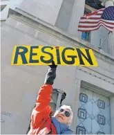  ?? SUSAN WALSH, AP ?? Cheryl Kreiser holds a sign outside the Justice Department. Attorney General Jeff Sessions recused himself Thursday but said he would not step down.