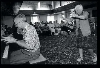  ??  ?? Clifford Matthews gets some crowd participat­ion going at one of his sessions at Longview, in 1996.