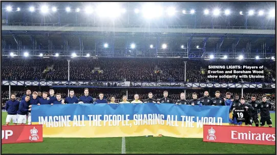  ?? ?? SHINING LIGHTS: Players of Everton and Boreham Wood show solidarity with Ukraine