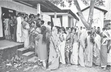  ??  ?? People wait in queues to cast their votes outside a polling station in Hojai district in the northeaste­rn state of Assam, India. — Reuters photo