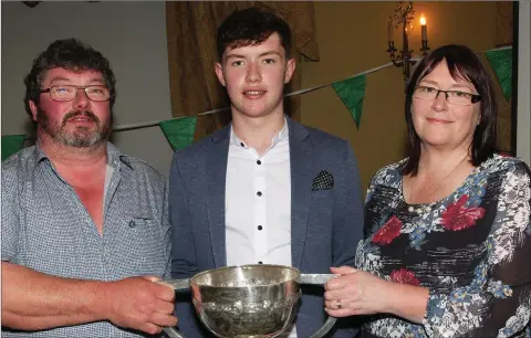  ??  ?? St. Peter’s College Senior football captain, Conor Firman, with his parents, David and Mary, at their medals presentati­on ceremony.
