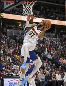  ?? AARON ONTIVEROZ — THE DENVER POST ?? Denver’s Jamal Murray attacks the cup as Precious Achiuwa of the New York Knicks defends at Ball Arena in Denver on Thursday.