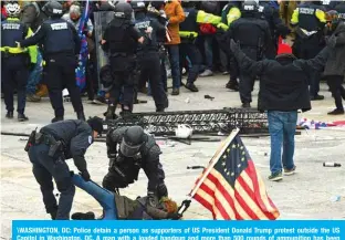  ??  ?? \WASHINGTON, DC: Police detain a person as supporters of US President Donald Trump protest outside the US Capitol in Washington, DC. A man with a loaded handgun and more than 500 rounds of ammunition has been arrested in Washington at a security checkpoint near the US Capitol, authoritie­s said.