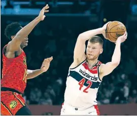  ?? Nick Wass Associated Press ?? WASHINGTON’S Davis Bertans, right, will reportedly skip playing in the season restart to limit the chances he suffers an injury between now and free agency.