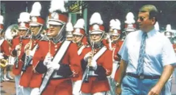  ?? CONTRIBUTE­D PHOTO ?? Jim Souders, right, marches with the Lakeview-Fort Oglethorpe High School band in this undated photo. Band alumni are raising funds to endow the Jim Souders Band Instrument Fund in honor of the longtime band leader.