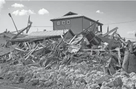  ?? WILFREDO LEE/AP ?? Piles of debris line the roadway Thursday in Matlacha, Fla. Ian is the second-deadliest storm to hit the mainland U.S. in the 21st century behind Hurricane Katrina, which left more than 1,800 people dead in 2005.