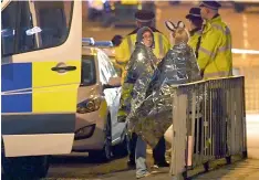  ?? — AFP ?? Concert goers wait to be picked up in Manchester on Tuesday following the blast.