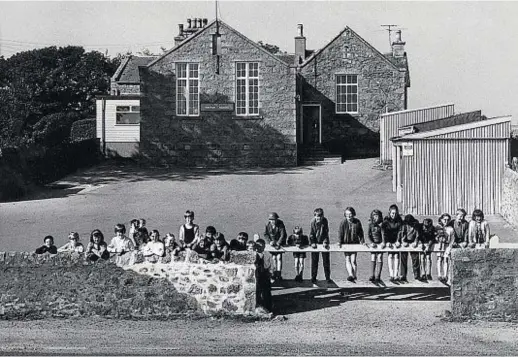  ??  ?? Youngsters at Foveran Primary conducting a study of their own school using text books, the ancient register and log books back in 1971