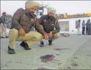  ?? HT PHOTO ?? Cops investigat­ing the crime scene at a petrol pump at Shampura near Majitha on Thursday.