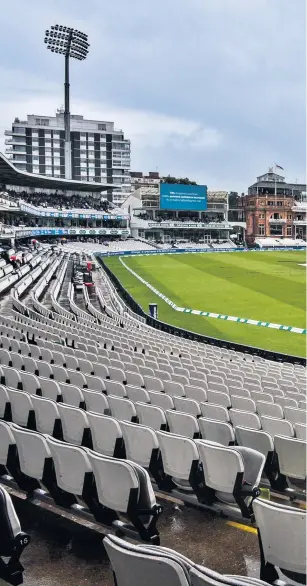  ??  ?? Rainy outlook: Covers protect the wicket on a frustratin­g day at Lord’s, while Joe Denly looks on (below)