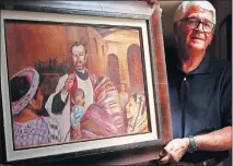  ?? [DOUG HOKE/ THE OKLAHOMAN] ?? Artist Chuck Schroeder, former president and executive director of the Cowboy Hall & Western Heritage Museum, shows his oil painting of Blessed Stanley Rother on Friday at the Catholic Pastoral Center.