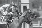  ?? Benoit Photo/Associated Press ?? UMBERTO RISPOLI rides Desert Dawn to victory over favored Adare Manor and John Velazquez.