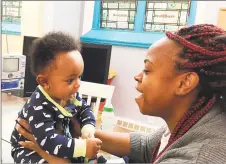  ?? Mary O’Leary / Hearst Connecticu­t Media ?? Zola Richardson, 27, plays with her son, 6-month-old Carl Bussey III at Life Haven, where she is living with her three children.