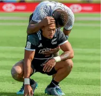  ?? PHOTO: PHOTOSPORT ?? Etene Nanai-Seturo is consoled byFiji’s Eroni Sau after New Zealand’s semi-final sevens tournament loss in Hamilton yesterday.