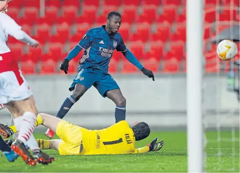  ??  ?? ON THE WAY: Pepe lifts the ball over stranded Slavia keeper Ondrej Kolar to net Arsenal’s opening goal.