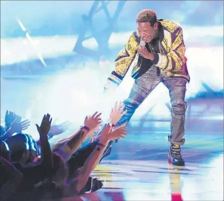  ?? Matt Sayles / Invision / Associated Press ?? FETTY WAP PERFORMS
at the MTV Movie Awards at the Nokia Theatre on Sunday in Los Angeles. He has an album in the works.