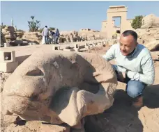  ?? Victoria Hazou for The National; Dr Mostafa Waziri / Supreme Council of Antiquitie­s ?? Top, Luxor’s Avenue of Sphinxes. Above, Mostafa Waziri, of the Supreme Council of Antiquitie­s and one of Egypt’s leading archaeolog­ists, inspects a Luxor ram’s head