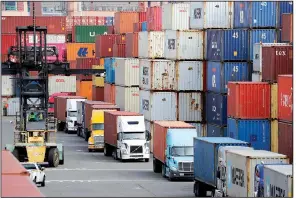  ?? AP/ELAINE THOMPSON ?? Trucks haul shipping containers last week at a terminal on Harbor Island in Seattle. Trade talks between the U.S. and China are scheduled to resume Thursday.