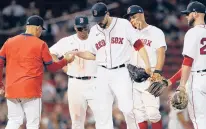  ?? MICHAEL DWYER/AP ?? The Red Sox’s Matt Barnes, center, hands the ball to manager Alex Cora after being taken out during the ninth inning against the Twins on Tuesday in Boston.