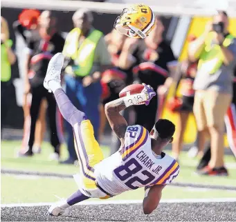  ?? STEPHEN M. DOWELL/ORLANDO SENTINEL VIA AP ?? LSU wide receiver D.J. Clark makes a reception against Louisville at Saturday’s Citrus Bowl.