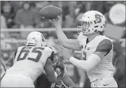  ??  ?? Mary Schwalm / The Associated Press
Syracuse quarterbac­k Eric Dungey (right) throws downfield during the first half of Saturday’s game.