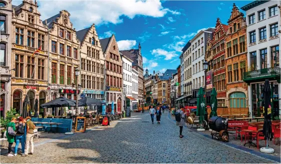  ??  ?? COBBLED CHARM: Open-air cafes along one of Antwerp’s elegant streets. Left: A typical art nouveau building on the stylish Cogels Osylei