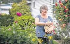  ?? CP PHOTO ?? Wendy Gould holds the cremated remains of her late husband, George Gould, at her home, in Aldergrove, B.C., on May 25.