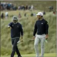  ?? MATT DUNHAM — THE ASSOCIATED PRESS ?? Rickie Fowler talks to Xander Schauffele of the United States as they walk to the 16th green during the third round of the British Open at Royal Portrush in Northern Ireland, Saturday.
