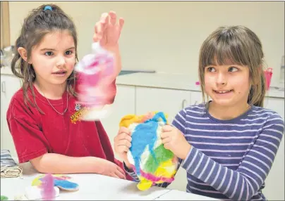  ??  ?? Jessie Smith, 6, of Frenchvale, left, and Erin Driscoll, 8, of Sydney, have fun with fibre during a Kids Fibre & Indigo Natural Dying workshop being held at the Cape Breton Centre for Craft and Design this week for students during the March break.