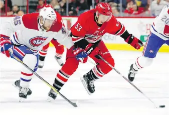  ??  ?? Hurricanes forward Jeff Skinner charges up ice against Canadiens forward Joe Morrow during the second period in Raleigh, North Carolina, on Wednesday.