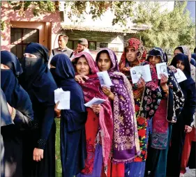  ?? IANS ?? Women voters standing in a queue to cast their votes in the first phase of the Uttar Pradesh Assembly elections in Agra on Saturday.