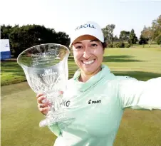  ?? — AFP photo ?? Alex pretends to take a selfie while holding the trophy after winning the Palos Verdes Championsh­ip.