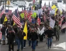  ?? LES ZAITZ — THE OREGONIAN VIA AP ?? Protesters march on Court Avenue in support of an Oregon ranching family facing jail time for arson in Burns, Ore., Saturday. Family members were convicted of the arsons three years ago and served time. But a judge ruled their terms were too short...