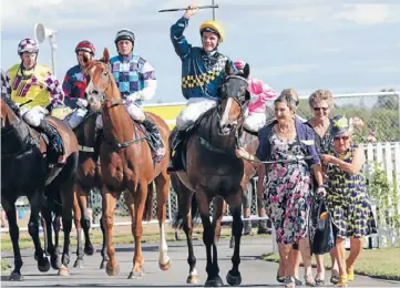  ??  ?? Well done: Viadana and victorious jockey Craig Grylls are escorted back after their NRM Sprint win by a trio of happy owners, including Tina Troughton, resplenden­t in her outfit that matches the Easdon Lodge racing colours.