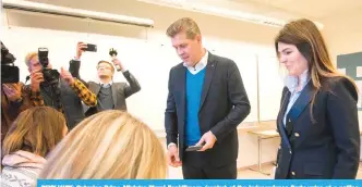  ?? —AFP ?? REYKJAVIK: Outgoing Prime Minister Bjarni Benidiksso­n (center) of the Independen­ce Party votes at a polling station during the election yesterday.