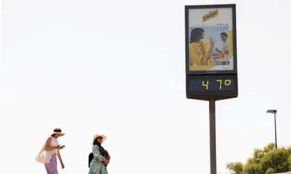  ?? Photograph: Marcelo del Pozo/Reuters ?? Women near a thermomete­r displaying 47C in Seville, Spain on 11 June.