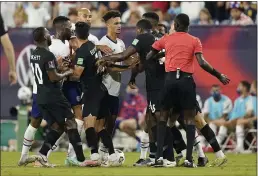  ?? MARK HUMPHREY — THE ASSOCIATED PRESS ?? An official, right, tries to break up a scuffle between players during the first half of a World Cup qualifier between the United States and Canada on Sunday in Nashville, Tenn.