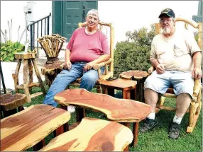  ?? RITA GREENE/MCDONALD COUNTY PRESS ?? Frank Jones, left, of Monett and Mike Parvi, known as Cedar Mike of Ridgely, showing their one-of-a-kind beautiful cedar furniture at Jesse James Days, Aug. 10-13 on the Square at Pineville.