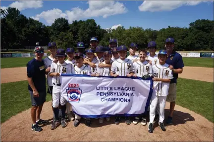  ?? COURTESY ERIC STROHM ?? The Upper Providence 12U Little League team poses with its state championsh­ip banner July 29. The team is currently competing at the Mid-Atlantic Regional in Bristol, Conn. where they are one win away from earning a spot in the Little League World Series.