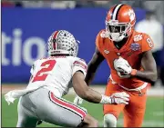 ?? AP/RICK SCUTERI ?? Clemson wide receiver Deon Cain (8) was suspended for last year’s national championsh­ip game after breaking team rules two days before the Tigers’ semifinal victory over Oklahoma. But Cain is back and ready to make an impact against top-ranked Alabama...