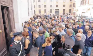  ?? ANDREW MEDICHINI/ASSOCIATED PRESS ?? People arrive to pay respect Sunday in the Rome church where Carabinier­i officer Mario Cerciello Rega was laid in state.