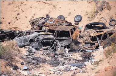  ?? ROBERTO E. ROSALES/JOURNAL ?? Cars and other trash sit in the bottom of a ravine on a parcel of state trust land that borders Zia Pueblo. A crew from the pueblo will clean the site and install a six-mile-long fence, paid for by the state Land Office. The fencing is intended to...