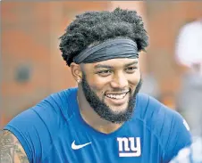  ?? Bill Kostroun; Getty Images ?? BIG SHOES TO FILL: Tomon Fox surpassed Lawrence Taylor (right) with 30 career sacks at North Carolina, and the undrafted rookie is hoping to help the Giants pass rush just as LT once did.