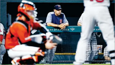  ??  ?? Alex Cora (centre) of the Boston Red Sox looks on during the game against the Baltimore Orioles at Oriole Park at Camden Yards on July 20 last year in Baltimore, Maryland.