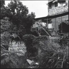  ??  ?? Delmo de Oliveira, outside his house in Vila Autódromo. One of the messages on the wall reads ‘Rio is favelas‘