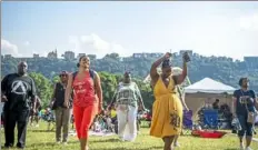  ?? Alexandra Wimley/Post-Gazette ?? People dance along to a choreograp­hed routine led by instructor Roland Ford at the Pittsburgh-Allegheny County Juneteenth Freedom Days Celebratio­n at Point State Park last June. This year’s celebratio­n will be June 17-19.