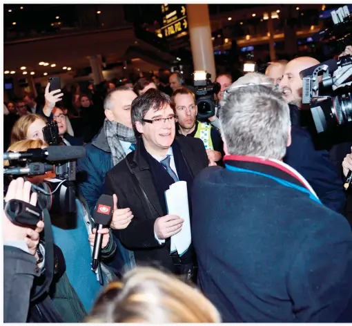  ??  ?? Former Catalan leader Carles Puigdemont answers journalist­s' questions upon his arrival at Copenhagen Airport on Monday. (AFP)