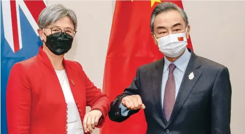  ?? Photo: AFP ?? Australia’s Foreign Minister Penny Wong bumps elbows with her Chinese counterpar­t, Wang Yi, on the sidelines of the G20 foreign ministers’ meeting in Bali in July.