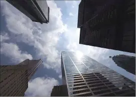  ?? Canadian Press photo ?? Bank towers are shown from Bay Street in Toronto's financial district in this file photo. Online banking, industry consolidat­ion, and changing regulation­s are making the divisions between credit unions and private banks fuzzier than ever, though some key difference­s remain.